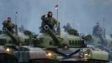 SERBIA-RUSSIA/PUTIN -- Serbian troops salute from the top of their tanks during a military parade to mark 70 years since the city's liberation by the Red Army in Belgrade October 16, 2014.